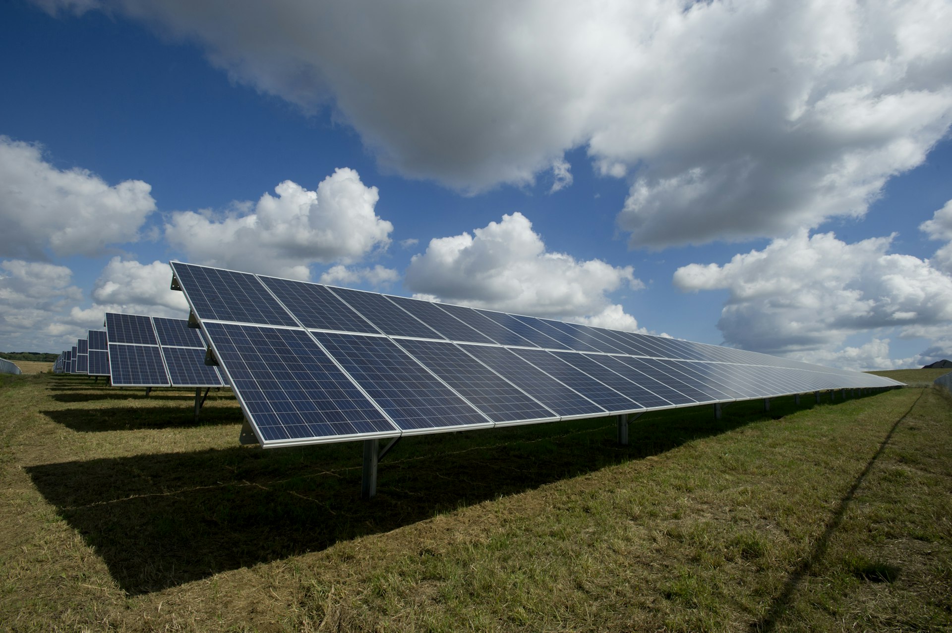 Solar panels in an open Spanish field under a clear sky